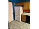 Kitchen with wood cabinets, white appliances and tile floor at 771 E Pepper Dr, Casa Grande, AZ 85122
