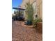 Stone patio with seating area, umbrella, and lush landscaping at 771 E Pepper Dr, Casa Grande, AZ 85122