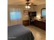 Spacious bedroom with large bed, dresser, and TV at 7950 E Keats Ave # 194, Mesa, AZ 85209