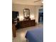 Bedroom with dresser, lamps, and a view into another room at 7950 E Keats Ave # 194, Mesa, AZ 85209