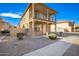 Two-story house with balcony, light-colored exterior, and landscaped front yard at 837 E Agua Fria Ln, Avondale, AZ 85323