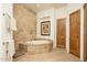 Bathroom with a large soaking tub and tile surround at 10803 E La Junta Rd, Scottsdale, AZ 85255