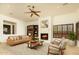 Open living room featuring a fireplace and natural light at 10803 E La Junta Rd, Scottsdale, AZ 85255
