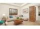 Bright living room featuring a sectional sofa, coffee table, and decorative pillows at 10803 E La Junta Rd, Scottsdale, AZ 85255