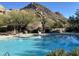 Inviting community pool with spa and mountain backdrop at 10803 E La Junta Rd, Scottsdale, AZ 85255