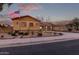 House exterior showcasing desert landscaping, a two-car garage and American flag at 12799 S 183Rd Dr, Goodyear, AZ 85338