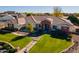 Aerial view of home showcasing a brick facade and manicured lawn at 21391 E Orchard Ln, Queen Creek, AZ 85142