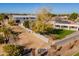 Aerial view of a house with a large backyard and a under construction building at 21391 E Orchard Ln, Queen Creek, AZ 85142