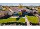 Aerial view of home with large green lawn and brick exterior at 21391 E Orchard Ln, Queen Creek, AZ 85142