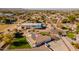 Aerial view of a house with a large backyard and under construction building at 21391 E Orchard Ln, Queen Creek, AZ 85142