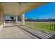 Covered patio with grassy backyard and white railing at 21391 E Orchard Ln, Queen Creek, AZ 85142