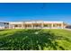 View of home's back and expansive grassy backyard at 21391 E Orchard Ln, Queen Creek, AZ 85142