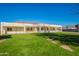 Spacious backyard with grassy lawn, mature trees, and a patio area at 21391 E Orchard Ln, Queen Creek, AZ 85142
