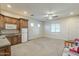Bright, open basement area with kitchenette and access to exterior at 21391 E Orchard Ln, Queen Creek, AZ 85142