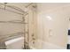 Clean bathroom with shower/tub combo and glass shelving at 21391 E Orchard Ln, Queen Creek, AZ 85142