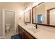 Double vanity bathroom with dark wood cabinets at 21391 E Orchard Ln, Queen Creek, AZ 85142