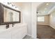 Elegant bathroom with a white vanity and ornate mirror at 21391 E Orchard Ln, Queen Creek, AZ 85142