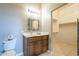 Clean bathroom with wood vanity and walk-in closet at 21391 E Orchard Ln, Queen Creek, AZ 85142