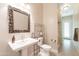 Clean bathroom with pedestal sink, shower, and updated fixtures at 21391 E Orchard Ln, Queen Creek, AZ 85142