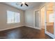 Bright bedroom featuring wood-look floors and access to an office at 21391 E Orchard Ln, Queen Creek, AZ 85142