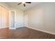Spacious bedroom with wood-look floors and an adjacent closet at 21391 E Orchard Ln, Queen Creek, AZ 85142