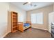 Charming bedroom with a bookshelf and window coverings at 21391 E Orchard Ln, Queen Creek, AZ 85142
