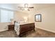 Comfortable bedroom with wood furniture and ceiling fan at 21391 E Orchard Ln, Queen Creek, AZ 85142