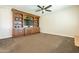 Spacious Gathering room with built-in shelving and a large TV at 21391 E Orchard Ln, Queen Creek, AZ 85142