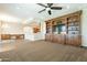 Gathering room featuring built-in entertainment center and plush carpet at 21391 E Orchard Ln, Queen Creek, AZ 85142