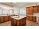 Large kitchen island with sink and breakfast bar at 21391 E Orchard Ln, Queen Creek, AZ 85142