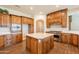 Spacious kitchen with island, wood cabinetry, and high-end appliances at 21391 E Orchard Ln, Queen Creek, AZ 85142