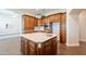 Kitchen island with sink, and wood cabinets at 21391 E Orchard Ln, Queen Creek, AZ 85142