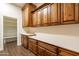 Laundry room with wood cabinets and a pantry at 21391 E Orchard Ln, Queen Creek, AZ 85142