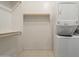 Convenient laundry room with stackable washer/dryer and shelving at 21391 E Orchard Ln, Queen Creek, AZ 85142