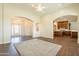 Open living room with kitchen views, high ceilings, and wood-look tile floors at 21391 E Orchard Ln, Queen Creek, AZ 85142