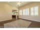 Living area with wood-look tile floors and views into kitchen at 21391 E Orchard Ln, Queen Creek, AZ 85142