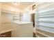 Spacious walk-in closet with built-in shelving and a separate bathroom access at 21391 E Orchard Ln, Queen Creek, AZ 85142