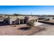 Aerial view of a stucco home with a two-car garage and desert landscaping at 29215 N 205Th Ln, Wittmann, AZ 85361