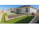 Artificial turf backyard with patio and trampoline near home at 38124 W Santa Barbara Ave, Maricopa, AZ 85138