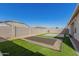 Spacious backyard with artificial turf, patio, and trampoline at 38124 W Santa Barbara Ave, Maricopa, AZ 85138