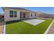 Large backyard with artificial turf and flagstone patio at 38124 W Santa Barbara Ave, Maricopa, AZ 85138