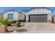 Single story home with a two-car garage and desert landscaping at 38124 W Santa Barbara Ave, Maricopa, AZ 85138