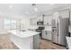 Modern kitchen with large island and stainless steel appliances at 38124 W Santa Barbara Ave, Maricopa, AZ 85138