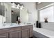 Bathroom with double vanity and a relaxing bathtub at 3949 E Monona Dr, Phoenix, AZ 85050