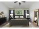 Virtually staged bedroom with a king-size bed and full-length mirror at 3949 E Monona Dr, Phoenix, AZ 85050