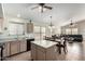 Open concept kitchen with island and view to living and dining area at 3949 E Monona Dr, Phoenix, AZ 85050