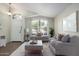 Virtually staged living room with grey sofas and coffee table at 3949 E Monona Dr, Phoenix, AZ 85050