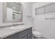 Updated bathroom with granite countertop, gray vanity, and tiled shower at 575 Leisure World --, Mesa, AZ 85206