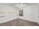 Bright bedroom with ceiling fan, wood-look floors, and built-in shelves at 575 Leisure World --, Mesa, AZ 85206