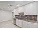 Kitchen boasts granite countertops and white cabinets at 575 Leisure World --, Mesa, AZ 85206